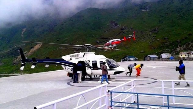 Helicopter on the Kedarnath helipad with guests boarding